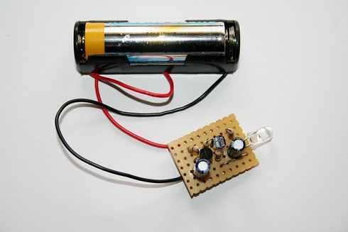 Betriebsfertiger Aufbau der Schaltung mit Batteriehalterung auf einer Lochrasterplatine.